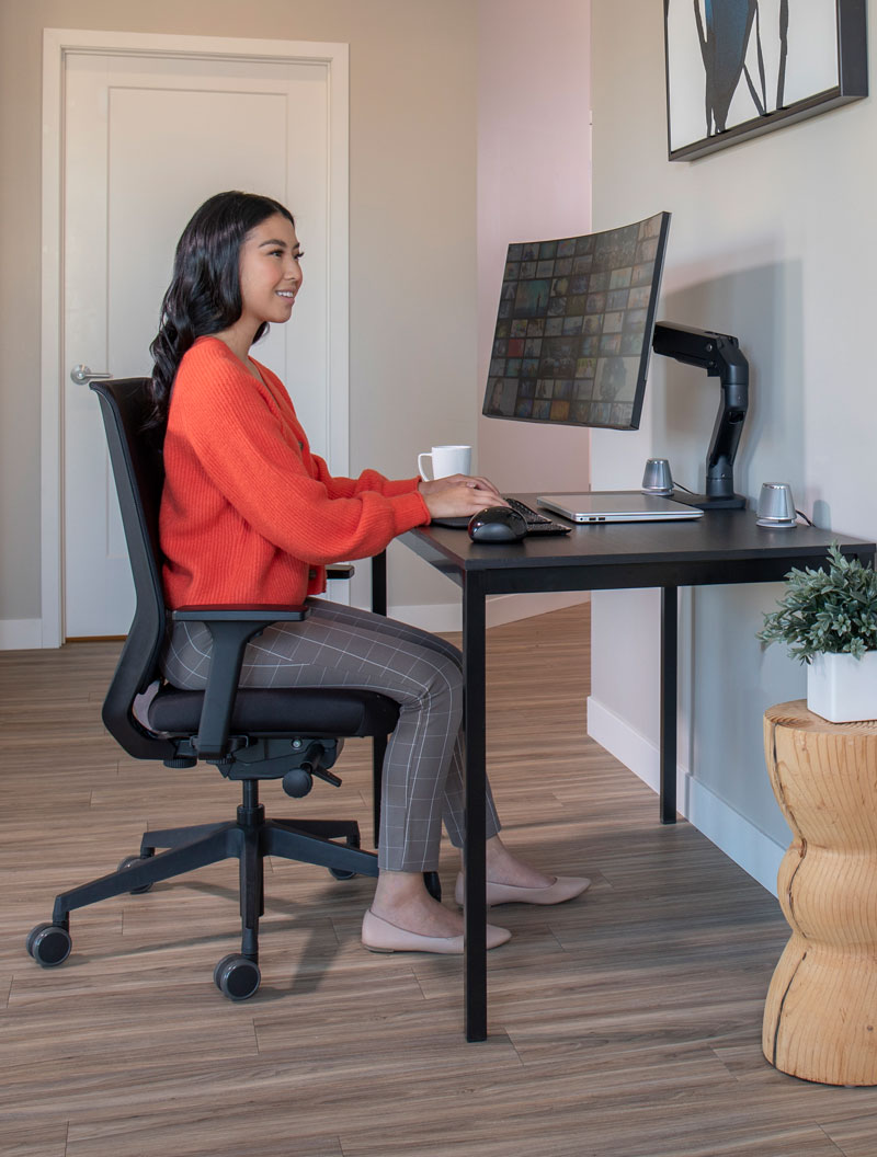 Woman using HX Arm in her home office